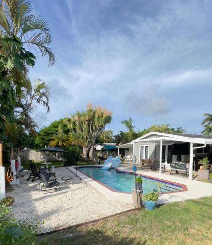 a house with a swimming pool and a house at Pool House Resort heated swimming pool private duplex in Cutler Bay