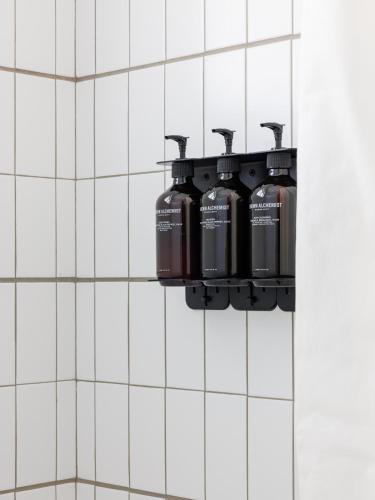 a bathroom with three water bottles hanging on a wall at The Outpost Rocky Mountains in Estes Park