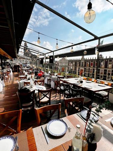 an outdoor restaurant with tables and chairs and lights at Domingo Santo Hotel Boutique in Mexico City