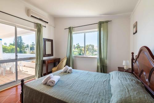 a bedroom with a bed and a large window at Villa Eulália in Guia