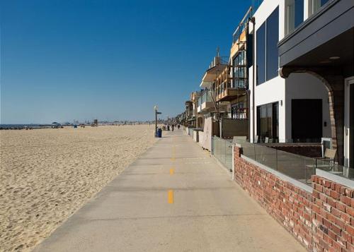 a sidewalk on the beach next to a building at 2314 W Oceanfront A & B in Newport Beach