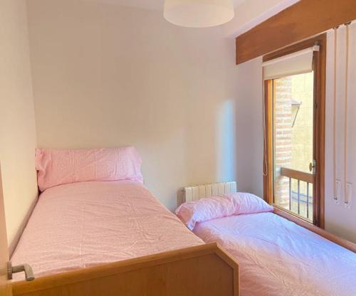a bedroom with two beds and a window at Sego Apartments I in Segovia