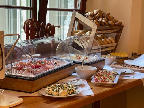 a table topped with different types of food on plates at Hotel Schwibbogen Altstadt & Appartements in Görlitz