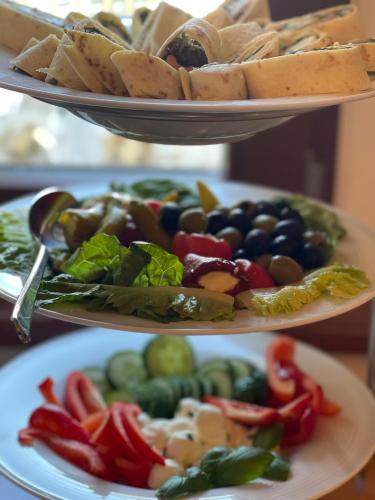two plates with different types of food on them at Hotel Schwibbogen Altstadt & Appartements in Görlitz
