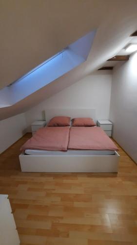 a bedroom with a bed in a attic at útulný podkrovní byt v centru Třebíče in Třebíč