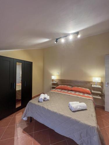 a bedroom with a large bed with towels on it at Beb dragonara in Torremaggiore