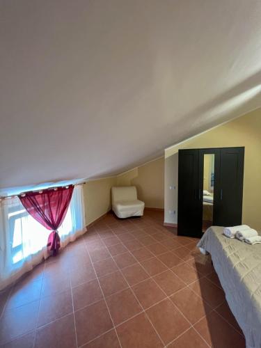 a large room with a bed and a window at Beb dragonara in Torremaggiore