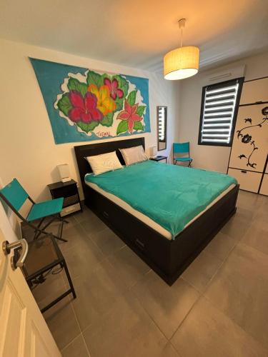 une chambre avec un lit avec un tableau sur le mur dans l'établissement BANDOL Magnifique appartement Vue mer Résidence Blue Bay, à Bandol