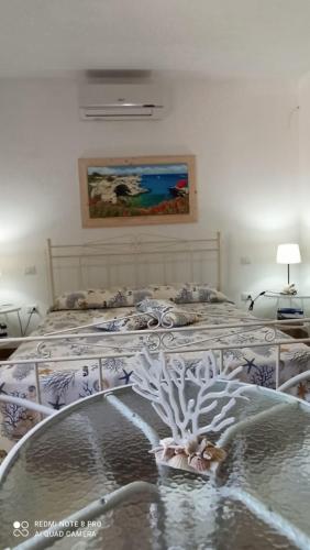 a bedroom with two beds and a painting on the wall at Anna's House in Borgagne
