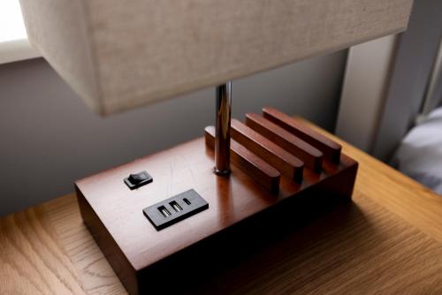 a wooden table with a small toy on top of it at MODERN 2 BeD APARTMENT in Enniskillen