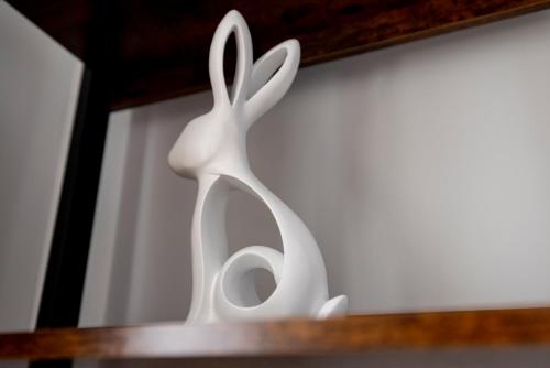 a white statue of a rabbit on a table at MODERN 2 BeD APARTMENT in Enniskillen