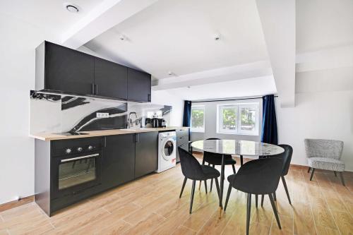 une cuisine avec une table et des chaises dans une pièce dans l'établissement Refreshing 2BD-6P apartment - 18th ard, à Paris
