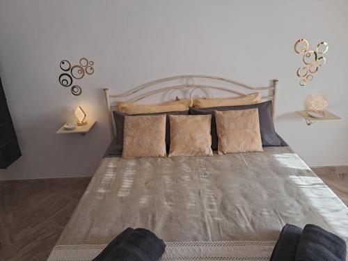 a bedroom with a large bed with pillows at CasaLina Apartment in Manduria