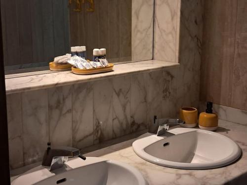 a bathroom with two sinks and a mirror at CasaLina Apartment in Manduria