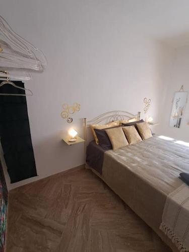 a bedroom with a large bed and a television at CasaLina Apartment in Manduria