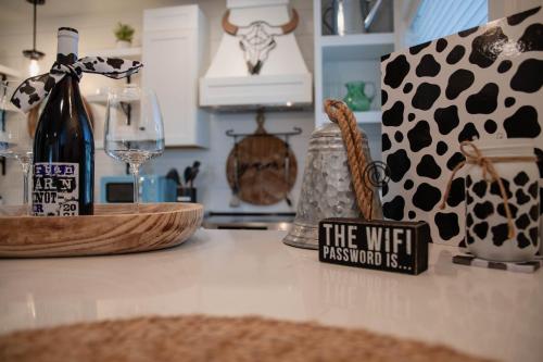 a bottle of wine on a counter in a kitchen at Walk to Best Eats and Shops and Stay in Style in Fort Myers