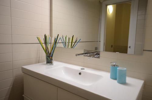 a bathroom with a white sink with a mirror at B&B Portanova in Salerno