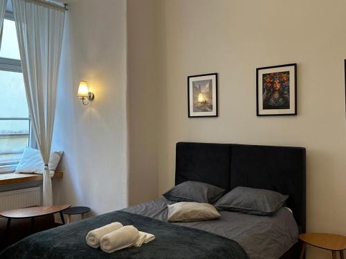 a bedroom with a bed with a towel on it at Rynek 5 Stara Winiarnia in Lublin