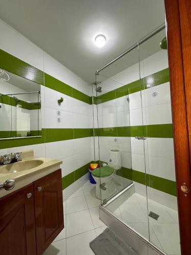 a bathroom with a glass shower and a toilet at Hotel Santris in Duitama
