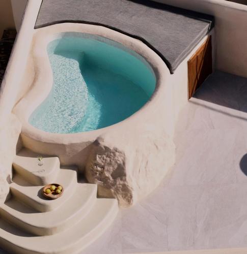 a pool with a staircase and a swimming pool at Manili Boutique Suites & Villas in Archanes