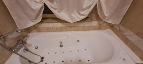 a bath tub in a bathroom with a shower at CasaLina Apartment in Manduria