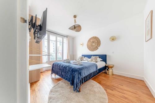 une chambre avec un lit avec une couette bleue dans l'établissement Bright & charming apartment - 1BR-4P - Montmartre, à Paris