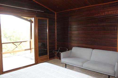 a living room with a couch and a window at Lake Prestige Villa Castelo de Bode, Tomar in Tomar