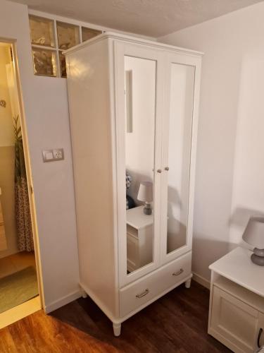 a white cabinet with a mirror in a room at Casa Playa Chica Lanzarote in Puerto del Carmen