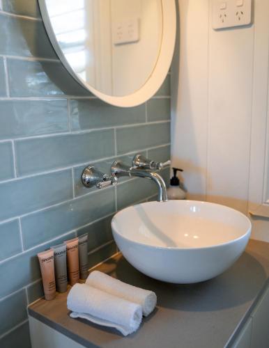 a bathroom with a white sink and a mirror at Finns at Old Bar in Old Bar