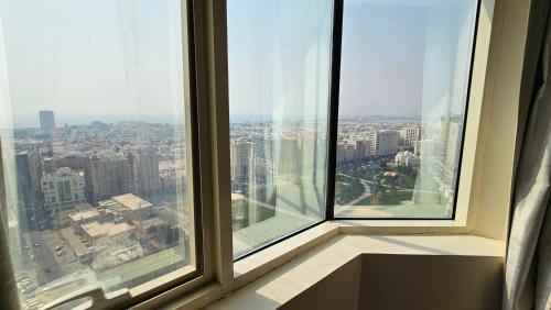 a view of a city from an office window at Splendid Private Rooms in Sharjah