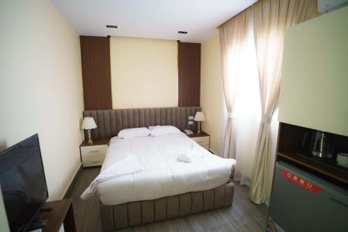 a hotel room with a bed and a television at Pyramids Sunshine View in Cairo