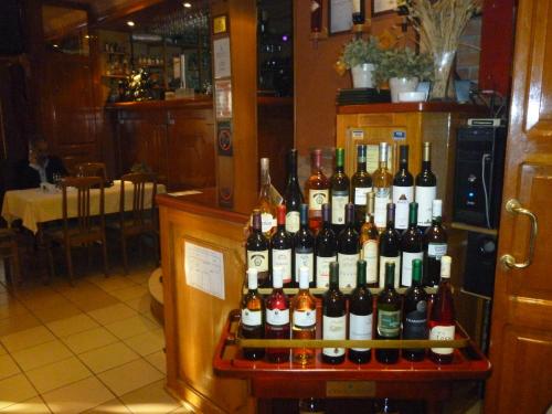 a display of wine bottles on a shelf in a restaurant at B&B Boem in Požarevac