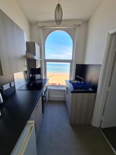 a kitchen with a large window and a kitchen counter at Farina No5, Sea view studio sleeping 2 guests in Bridlington