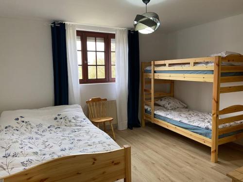 a bedroom with two bunk beds and a window at Magnifique maison spa in Aix-en-Ergny