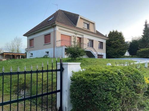 a large house with a fence in front of it at Magnifique maison spa in Aix-en-Ergny