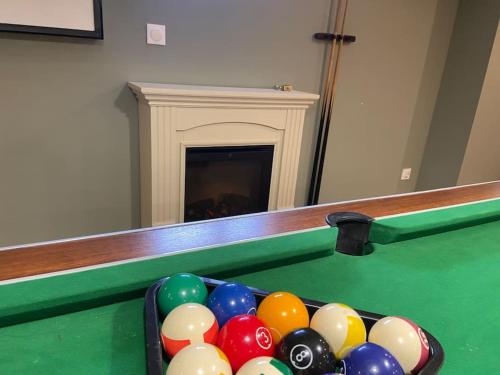 a pool table with a bunch of balls on it at Magnifique maison spa in Aix-en-Ergny