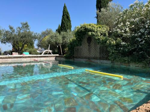 a swimming pool with blue water and yellow tubes at I Fontanili in Civita Castellana