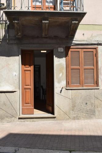 an open door of a building with a balcony at Casa vacanze all'archetto in Villa San Giovanni in Tuscia
