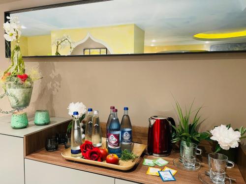 a shelf with bottles of soda and vegetables on it at Hotel Burgwirt in Deggendorf