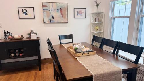 a dining room with a wooden table and chairs at Modern and Cozy Pine Hills Home from Early 1900s in Albany