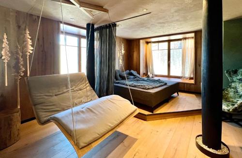 a swing in a room with a bed and a window at Post-Hotel in Mittenwald