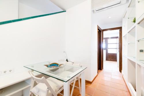 a kitchen with a glass table and a chair at Wekey Homes, Casa del Albaicyn in Granada