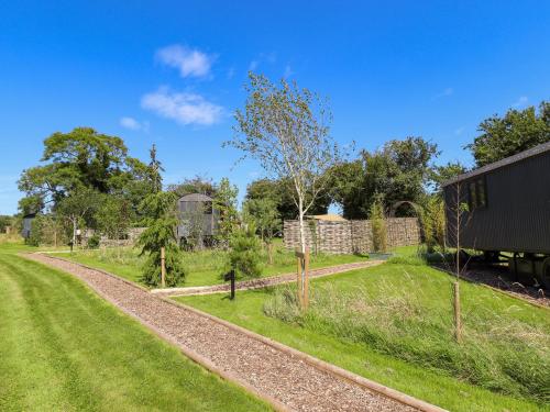 a train track next to a field with trees at Limetree Luxury Glamping Southdown in Retford