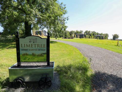 a sign on a gravel road next to a park at Limetree Luxury Glamping Southdown in Retford