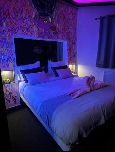 a woman laying on a bed in a bedroom at Le Pink in Aubervilliers