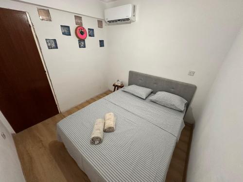 a bedroom with a bed with two shoes on it at 3 bedroom apartment opposite Kyrenia harbor in Kérynia