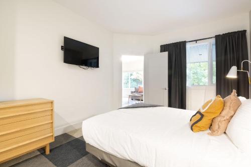 a bedroom with a bed and a tv on the wall at Whistler Vacation Club at NorthStar in Whistler
