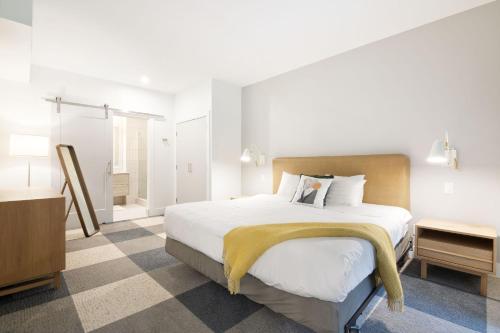 a bedroom with a large bed and a bathroom at Whistler Vacation Club at NorthStar in Whistler