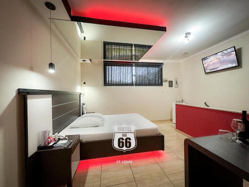 a bedroom with a bed with a sign on it at MOTEL MK 66 in Mairinque
