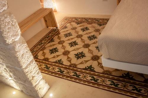 a bedroom with a bed and a carpet at G home in Fasano